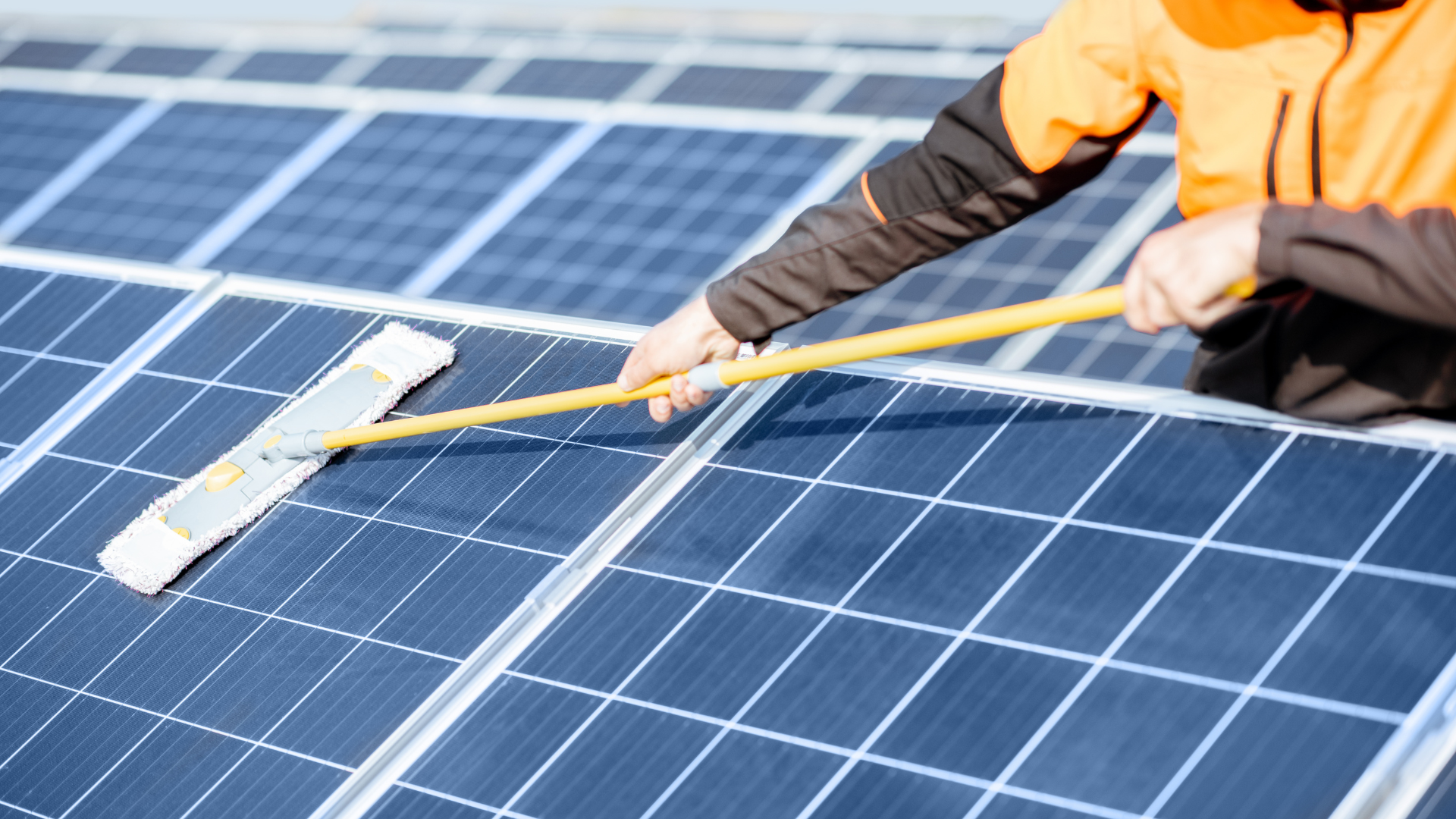 Cleaning solar panels with a mop